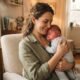 Mother comforting her congested baby upright against her shoulder near a humidifier in a nursery