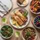 Colorful anti-inflammatory, prebiotic-rich meal spread with salmon, legumes, garlic, and berries