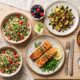 Meal plan for PCOS to balance hormones — low-glycemic spread with salmon, quinoa, and roasted vegetables
