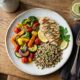Overhead view of a balanced dinner plate with vegetables, whole grains, and lean protein, illustrating nutrition basics