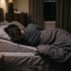 Person sleeping on their left side with a wedge pillow to reduce nighttime acid reflux