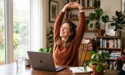 Woman stretching at her home desk during a work break to stay healthy while working from home