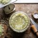 A jar of homemade sauerkraut fermenting, with a kitchen scale for precise salt measurement
